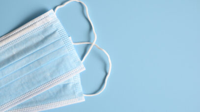 medical masks blue color to cover the mouth and nose for protection from bacteria on a blue background. space for text